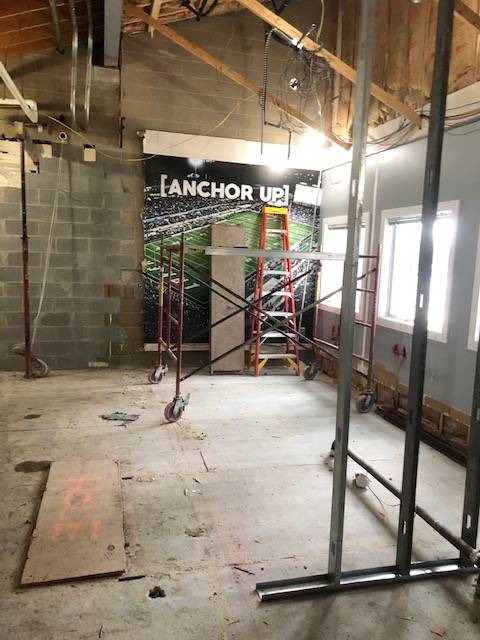 Sign in the photo says, Anchor Up! It's in a room under construction.